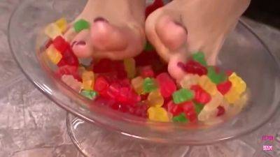 A Kinky Brunette Sticks Her Feet In Gummy Bears And Performs A Footjob Until Cumshot - hotmovs.com